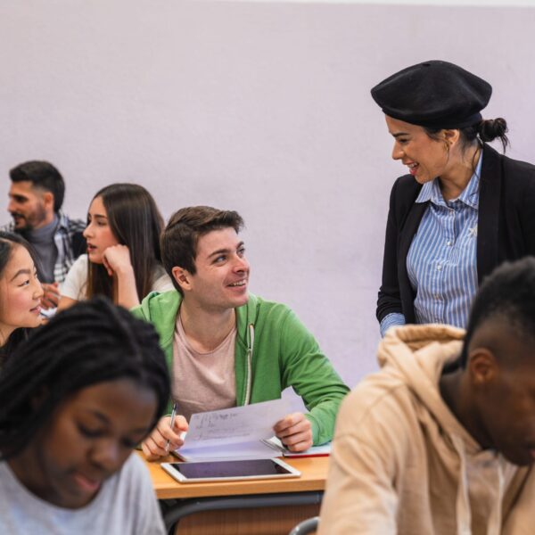 High school teacher assisting students during a lesson, fostering engagement and knowledge in the classroom
